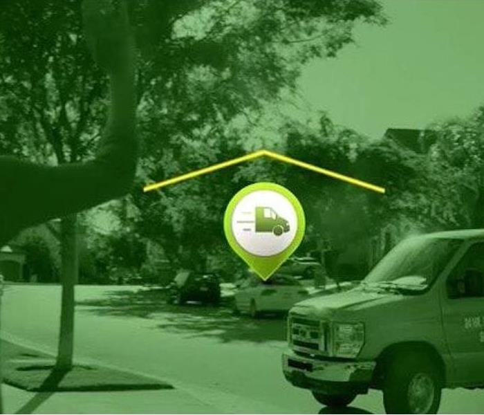 SERVPRO green van arrives to a house with woman in driveway